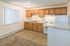 Cozy kitchen with wooden cabinets, modern appliances, and abundant natural light. Perfect for culinary creativity.