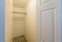 Spacious walk-in closet with smooth carpeting and plenty of hanging space, perfect for organizing your wardrobe.
