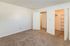 Bright and inviting bedroom with plush carpet and ample closet space, ideal for creating a cozy sanctuary.