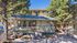 Charming apartment complex with lush greenery, featuring cozy seating and vibrant flowers, ideal for serene living.