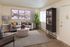 Inviting living room with elegant decor featuring a plush sofa, modern art, and abundant natural light.