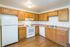 Charming kitchen with warm wooden cabinets, modern appliances, and ample counter space.