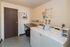 Modern laundry room with efficient washers and convenient folding area, perfect for hassle-free living.