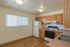 Bright and inviting kitchen with modern appliances, sleek countertops, and ample wooden cabinetry.