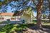 Charming outdoor picnic area with shelter, nestled in a serene apartment community, perfect for relaxation under the shade of tall trees.