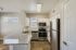 Modern kitchen with sleek granite countertops, stainless steel appliances, and bright natural light.