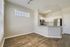Modern open-plan kitchen with sleek stainless steel appliances, chic granite countertops, and elegant wood flooring.