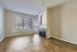 Bright room with hardwood floors, a cozy fireplace, and large windows offering abundant natural light.