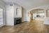 Elegant modern apartment with open-concept layout, featuring sleek hardwood floors, a granite countertop kitchen, and a cozy fireplace.