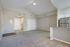 Bright apartment space with vaulted ceilings and a modern kitchen featuring stainless steel appliances and granite countertops.