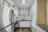 Modern kitchen with sleek stainless steel appliances, elegant granite countertops, and abundant natural light through wide windows.