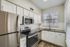 Inviting modern kitchen with sleek stainless steel appliances, elegant granite countertops, and bright white cabinetry.