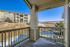 Charming apartment balcony with stunning views of landscaped grounds and open fields, perfect for relaxation.