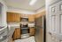 Contemporary kitchen boasting stainless steel appliances, elegant wood cabinetry, and polished granite countertops.