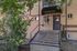 Charming apartment entrance with brick facade and green foliage at Park Place Apartments, offering a welcoming atmosphere.