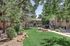 Charming apartment complex with lush greenery and inviting outdoor seating, perfect for relaxation and leisure.