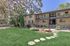 Charming apartment building surrounded by lush greenery and tranquil scenery, offering a peaceful living environment.