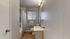 Bright and modern bathroom featuring elegant fixtures, wood flooring, and a stylish patterned shower curtain.