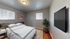Inviting bedroom with elegant decor featuring a plush bed, stylish wall art, and a large flat-screen TV creating a perfect relaxation space.