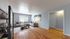 Inviting living room with elegant decor, featuring a plush sectional sofa, warm hardwood floors, and ambient natural light through large windows.