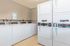 Modern laundry room with convenient stackable washers and dryers, featuring user-friendly digital controls.