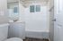 Bright, modern bathroom with sleek fixtures and elegant white tiles.