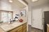 Inviting open-concept kitchen and dining area featuring elegant countertops, modern appliances, and stylish artwork, perfect for entertaining.