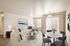 Elegant living room with cozy sectional sofa, chic round glass coffee table, and stylish dining area, complemented by soft natural light and modern decor.