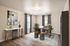 Modern home office with elegant furnishings, featuring a sleek desk, stylish seating, and decorative artwork, illuminated by natural light.
