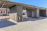 Modern covered parking area with sleek concrete flooring and secure gated access.