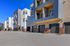 Modern apartment complex with sleek architecture, spacious balconies, and mountain views, perfect for urban living.