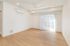 Bright and airy living space with sleek wood flooring, modern ceiling fan, and large window with vertical blinds, perfect for a cozy and contemporary home.