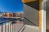 Charming apartment balcony with stunning mountain views and vibrant blue sky, perfect for relaxing afternoons.