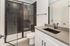 Contemporary bathroom featuring a chic black-tiled shower, sleek modern fixtures, and elegant vanity.