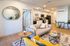 Chic modern living room with stylish furniture, open-concept layout, and a cozy kitchen perfect for entertaining.