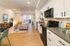 Modern open-plan apartment interior with elegant kitchen, stylish living room, and natural light.