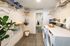 Modern laundry room with sleek appliances, ample shelving, and elegant decor for organized living.