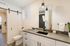 Modern bathroom with sleek countertops, stylish lighting, and a sliding barn door, offering a tranquil and contemporary space.