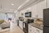 Modern open-concept kitchen with sleek cabinetry, inviting lounge area, and natural light through sliding glass doors.