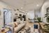 Chic open-concept living space featuring a modern kitchen, cozy sofa, stylish decor, and ample natural light.