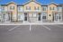 Charming townhouses with modern design, featuring stone accents and spacious front porches in a serene neighborhood.
