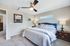 Inviting bedroom with plush bedding, elegant decor, and soft lighting, creating a serene retreat.