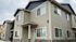 Charming two-story townhouse with modern exterior and ample windows, ideal for natural light and suburban living.