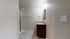 Elegant bathroom featuring modern shower, granite countertop vanity, and ambient lighting for a relaxing atmosphere.