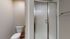 Modern bathroom with sleek glass shower enclosure and a chic white toilet, offering a clean and contemporary design.