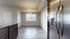 Elegant open-concept kitchen and dining area with modern flooring and stainless steel appliances.