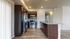 Modern kitchen with stainless steel appliances, sleek granite countertops, and dark wood cabinetry, offering a stylish and inviting space.