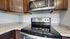 Modern kitchen featuring sleek stainless steel appliances, elegant granite countertops, and rich wooden cabinetry.