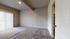 Bright and spacious room with plush carpeting and large window offering abundant natural light.
