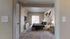 Inviting bedroom featuring a plush bed with elegant decor, soft carpet flooring, and a sunlit window for a cozy ambiance.